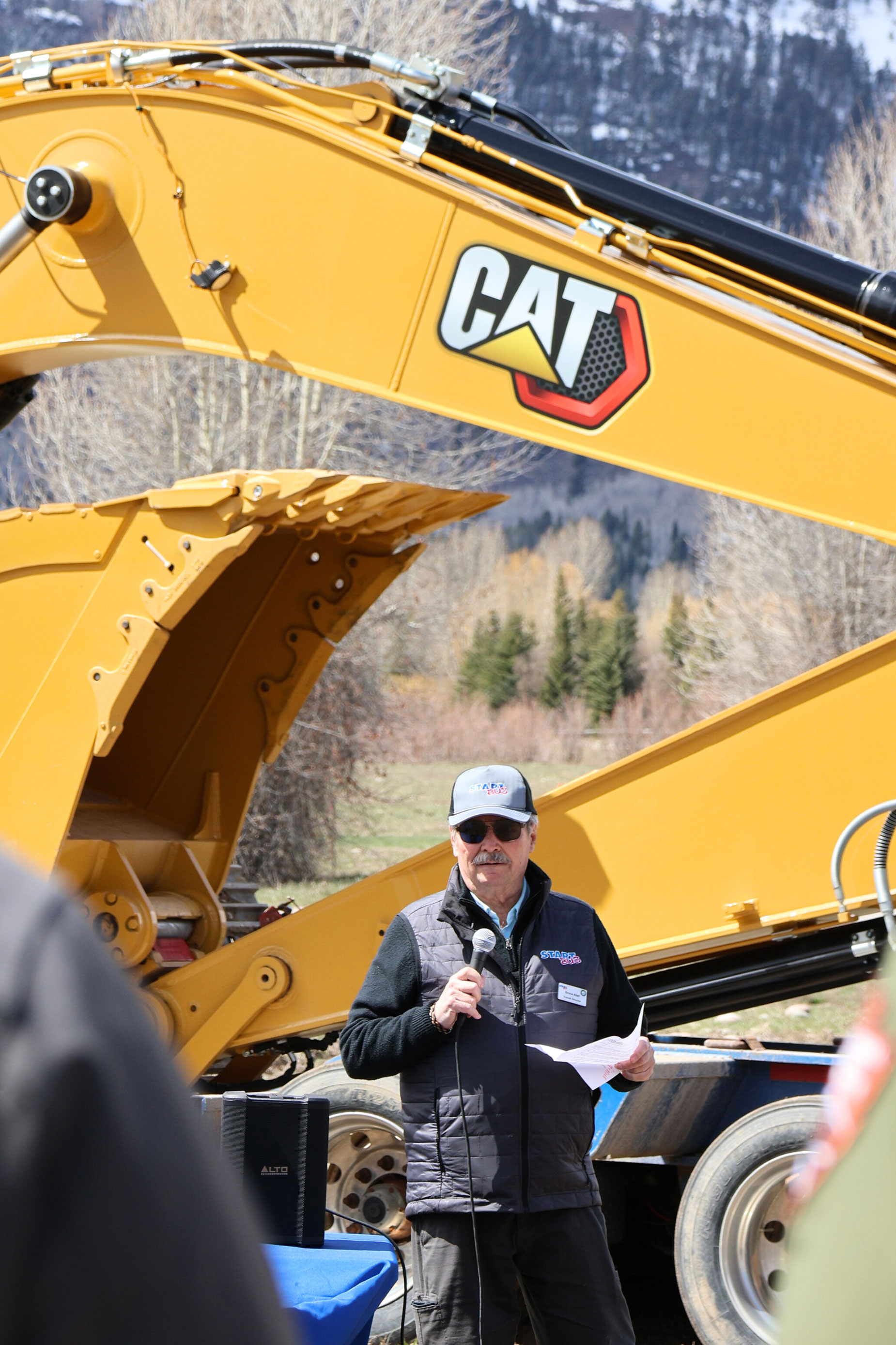 Speech in front of construction equipment